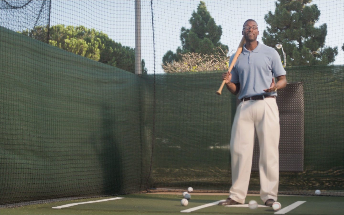 Man in a batting cage holding a baseball bat over his shoulder, ready to swing. | Jerad Schutt | Nashville Marketing Consultant | Fractional CMO | Jerad Schutt | Nashville Marketing Consultant | Fractional CMO