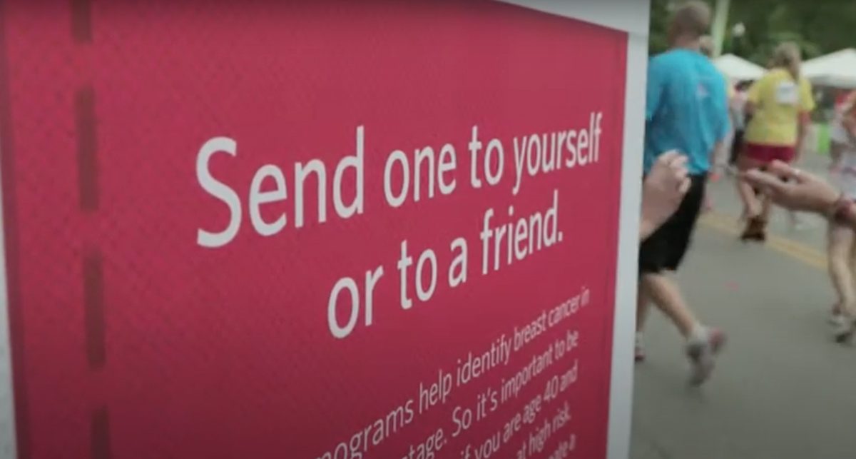 Banner reads: 'Send one to yourself or to a friend' at a pink event display; people walking in the background. | Jerad Schutt | Nashville Marketing Consultant | Fractional CMO | Jerad Schutt | Nashville Marketing Consultant | Fractional CMO